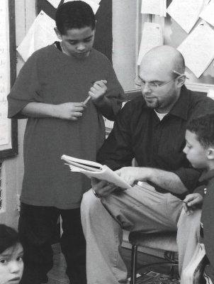 Drew Yakawiak '03 works with a student