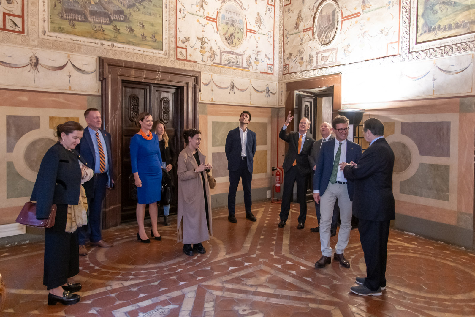 group of people looking at designs in a decorative room