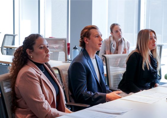 Four students listen to professionals in the motion picture industry