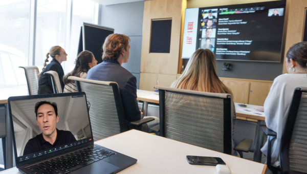Students listen to a professor deliver a lecture.