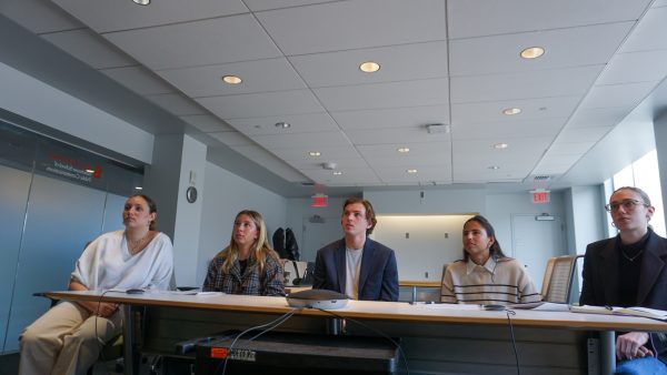 Students listen to a presentation.