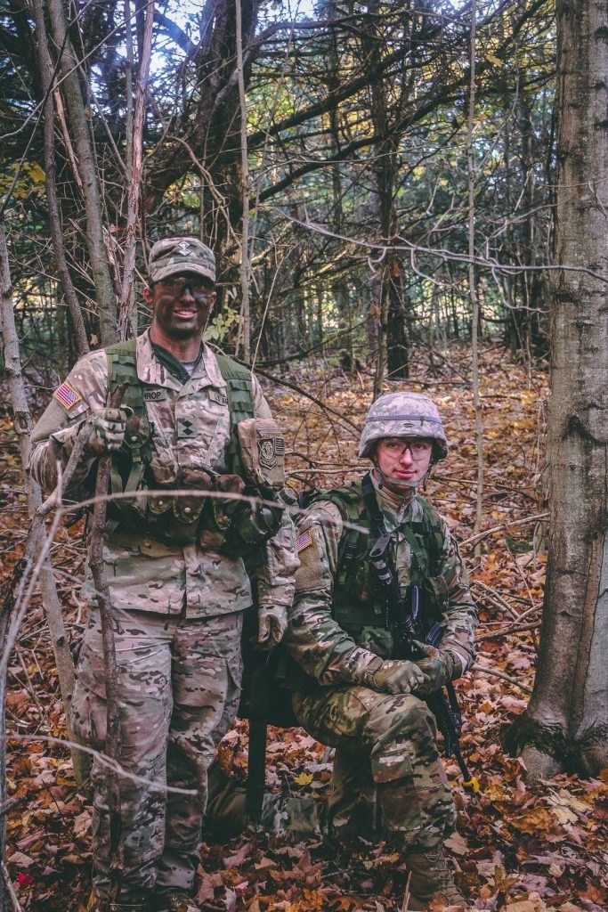 two people in military fatigues in the woods