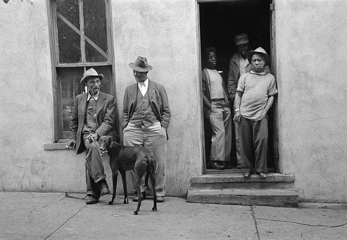five people standing outside doorway