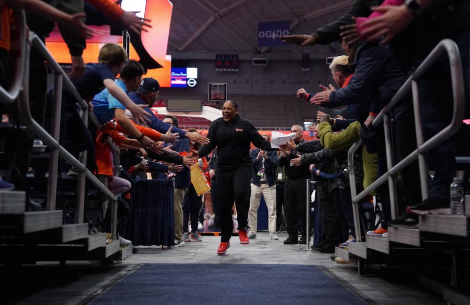 Coach Felisha Legette-Jack '89 walking down the tunnel giving high-fives to fans.