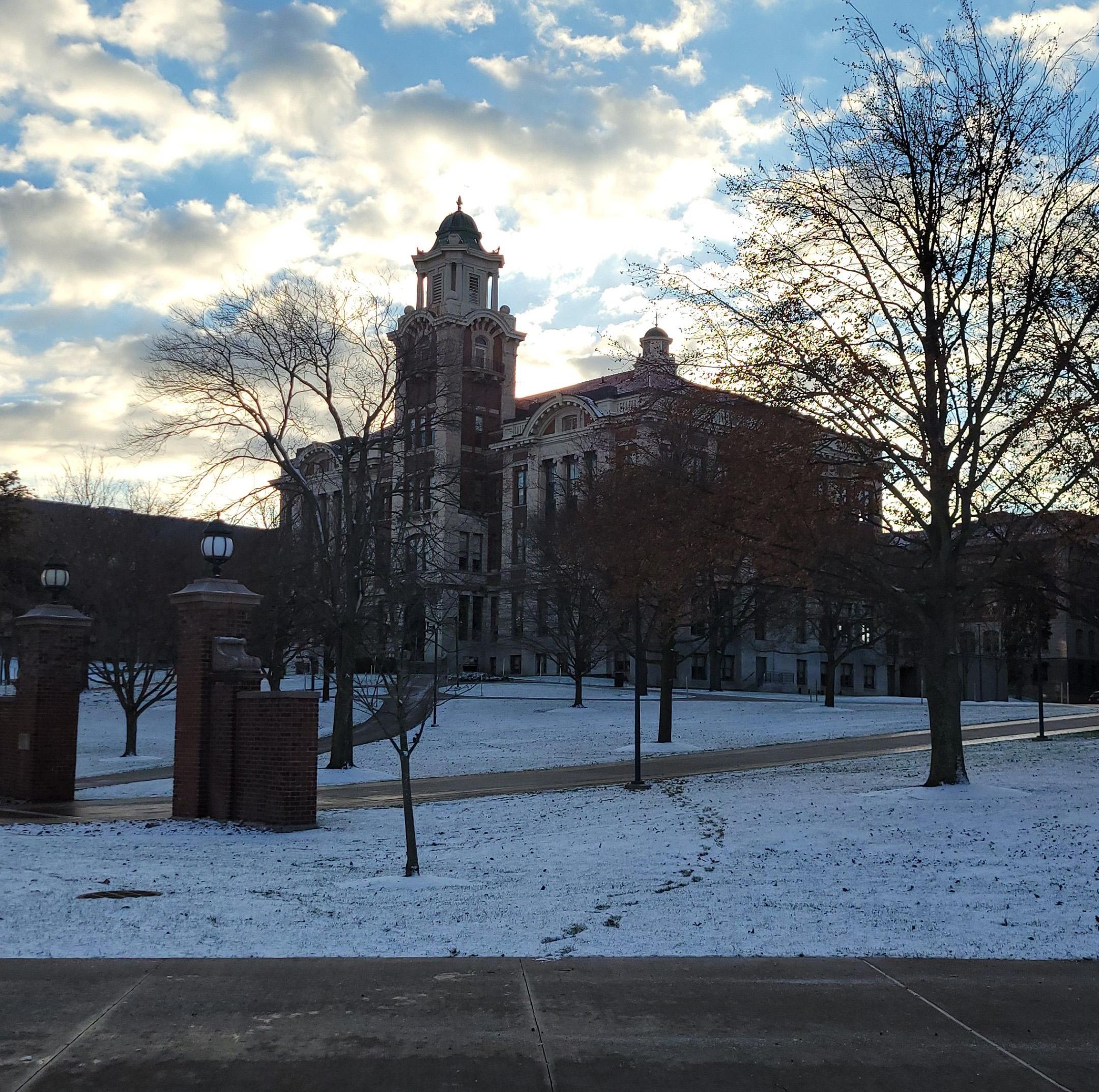 Sun rising behind Lyman Hall on a snowy day.