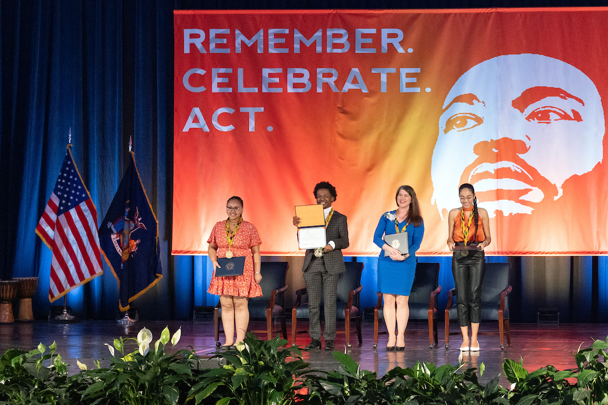 Four people standing on stage at the Annual Rev. Dr. Martin Luther King Jr. Celebration