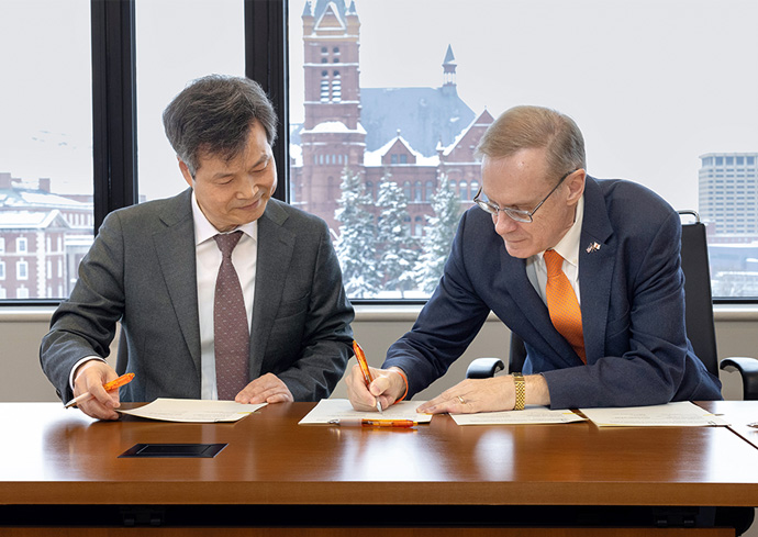 Chancellor Kent Syverud and University of Seoul President Yongkul Won sign a memorandum of understanding in an office on campus