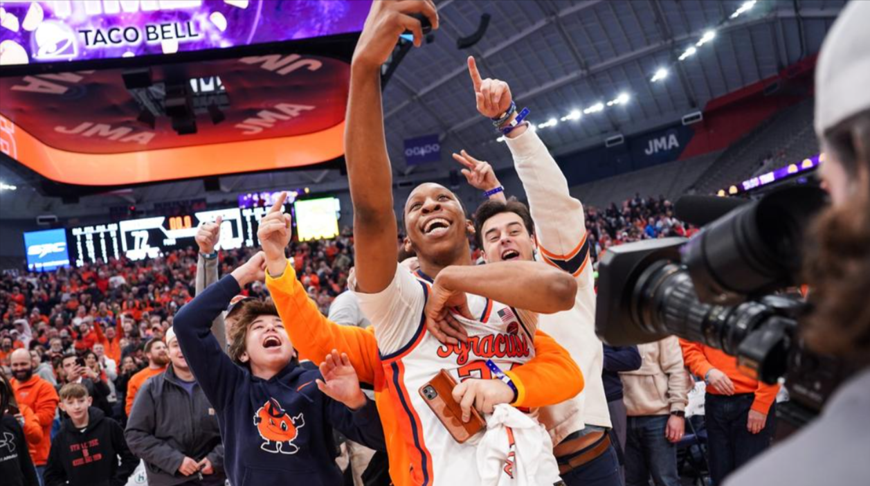 men's basketball player Quadir Copeland celebrates with fans after win in the JMA Wireless Dome