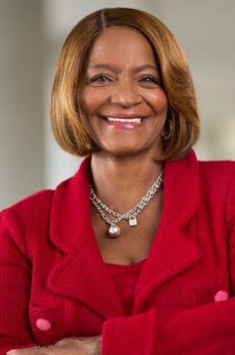 A woman smiles for a headshot