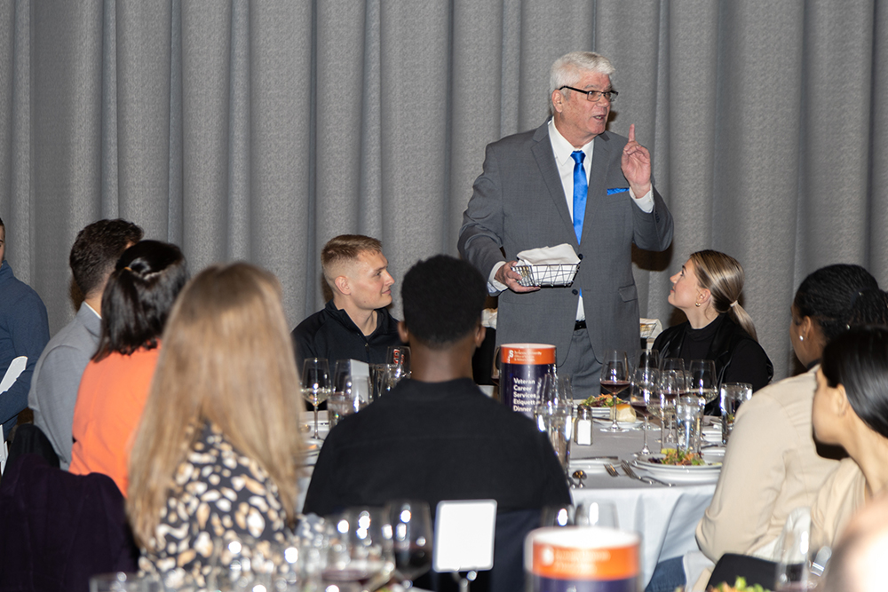 presenter speaks at an etiquette dinner as part of Veterans Career-Ready Bootcamp