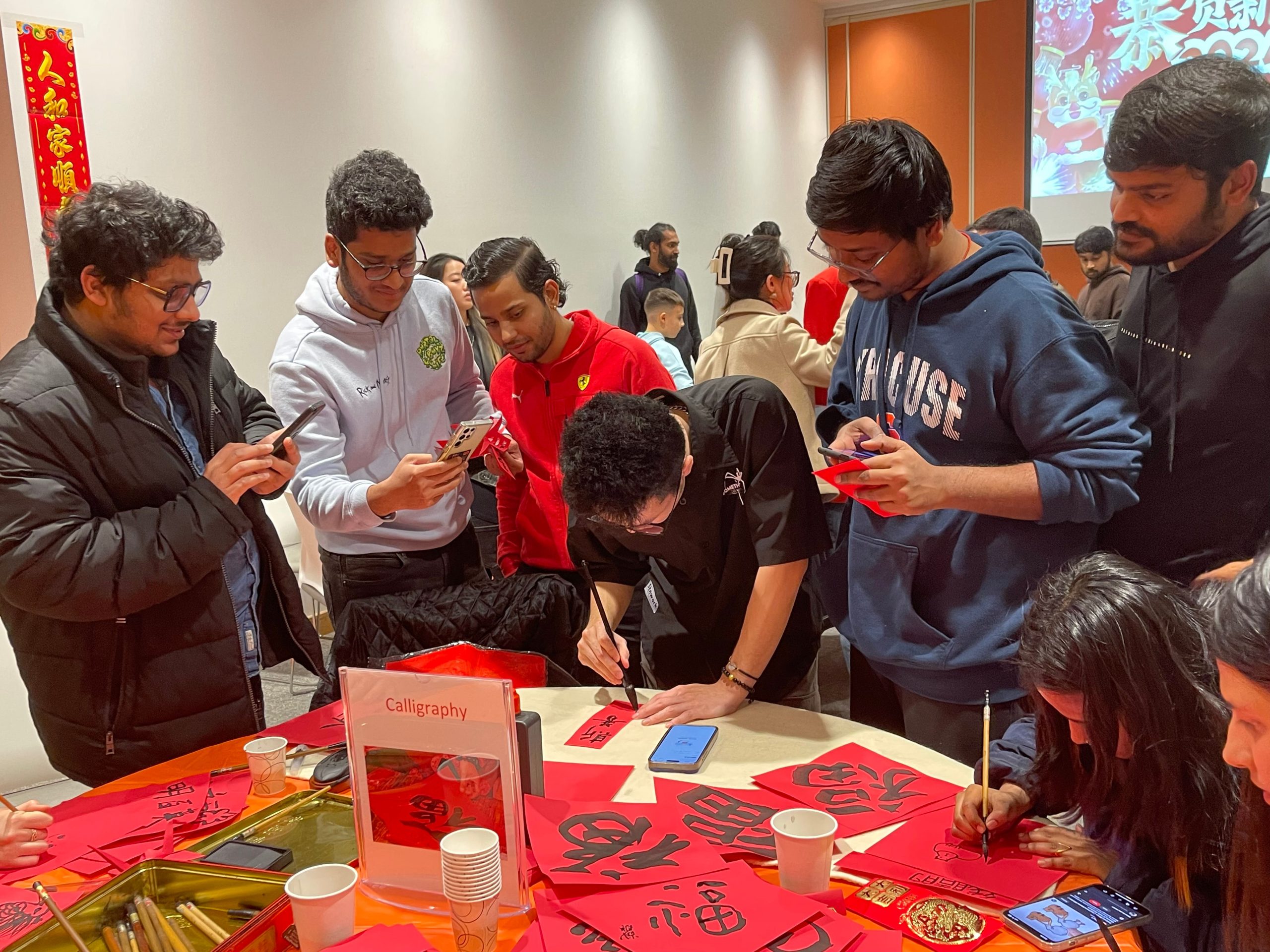 Group of people standing around a table working on an activity.