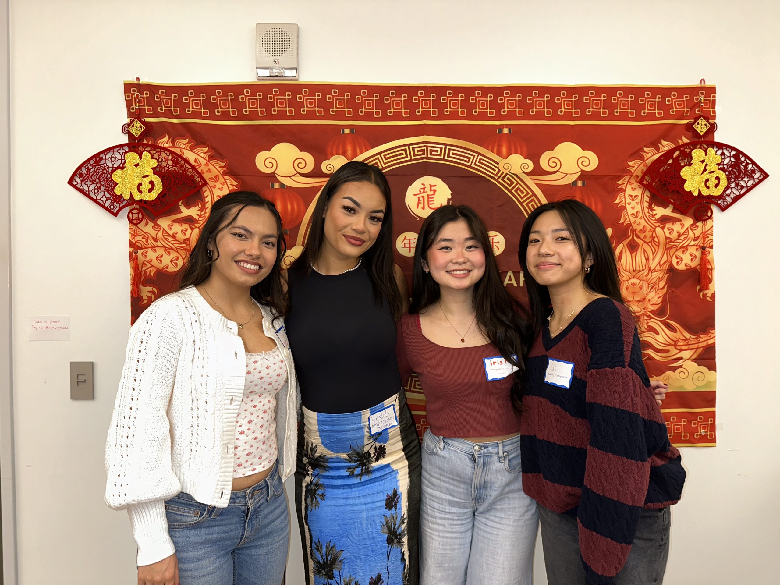 Four people standing together for a photo.