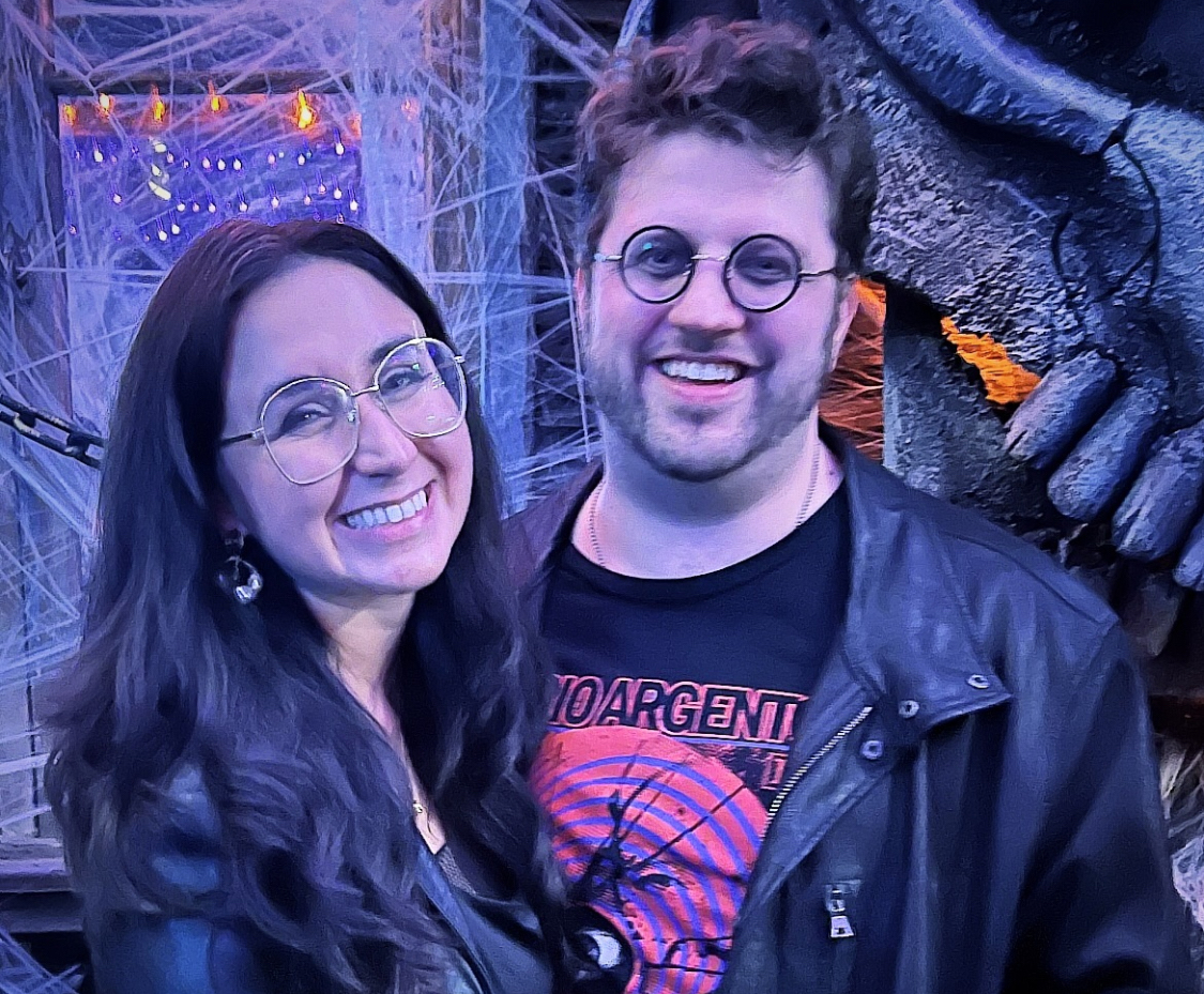 Two people standing together smiling