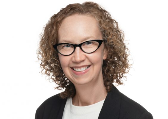 A woman smiles while posing for a headshot.
