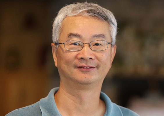 A man smiles while posing for a headshot.
