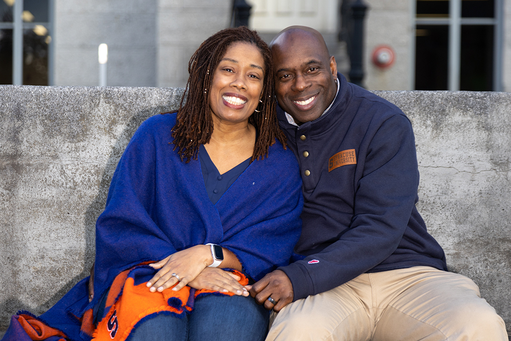 Allison Murray and Dwayne Murray pose together on the kissing bench