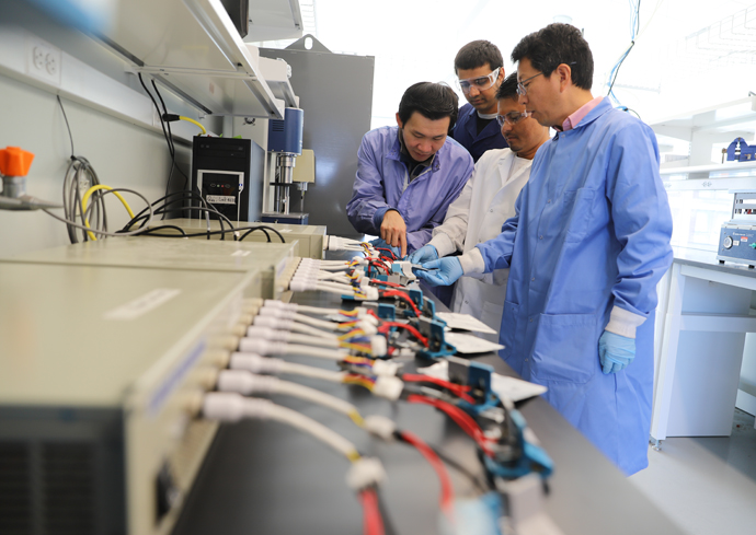 Graduate students conduct research in a lab.