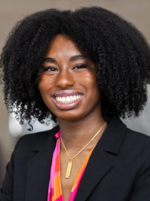 A woman smiles while posing for a headshot.