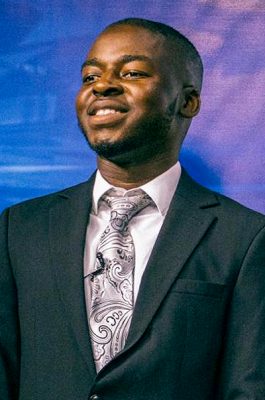 A man smiles while posing for a headshot