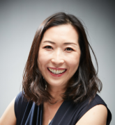 smiling person with shoulder length dark hair
