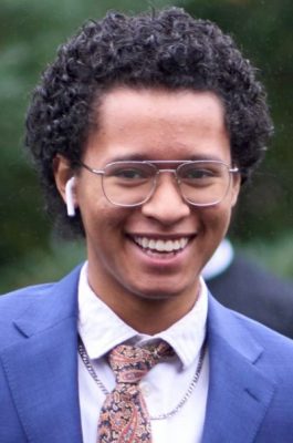 A man smiles while posing for a headshot.