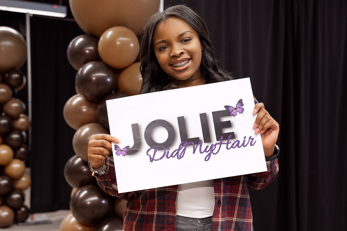 A student smiles after having her hair done.