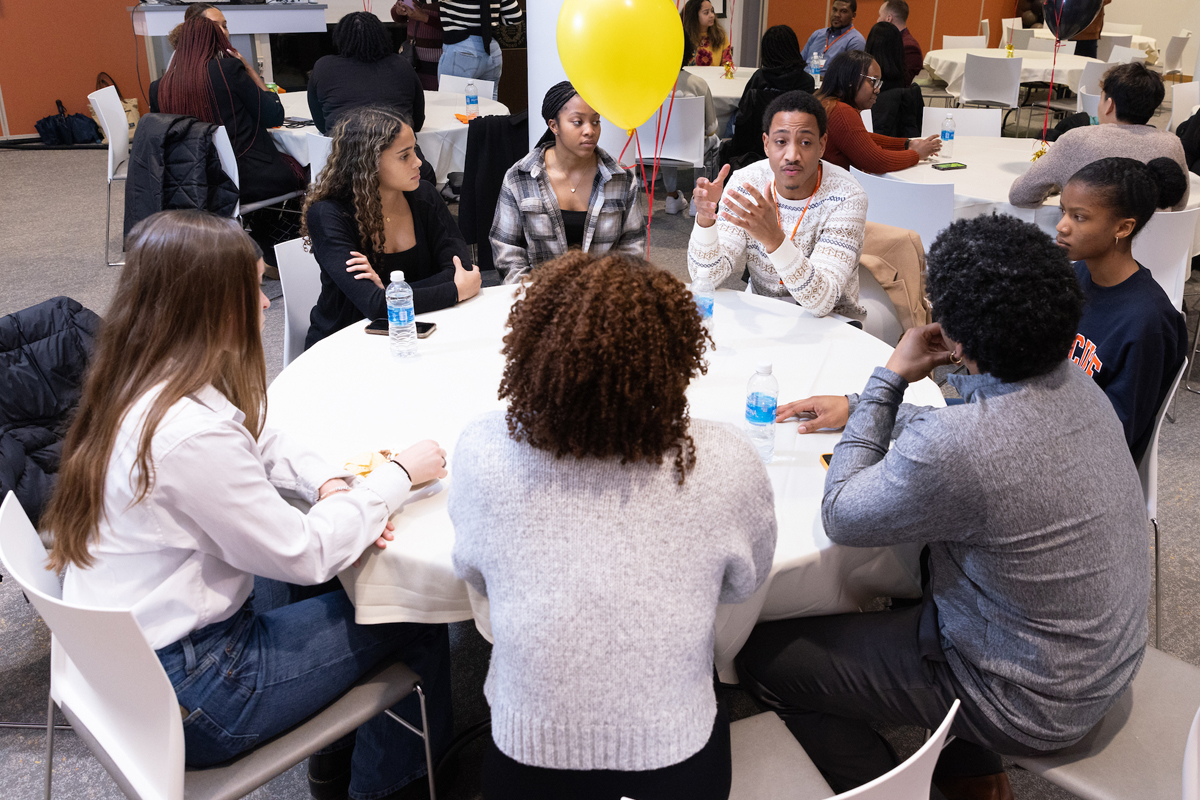 Students engage in discussion with alumni about career advice.