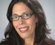 woman with glasses smiling