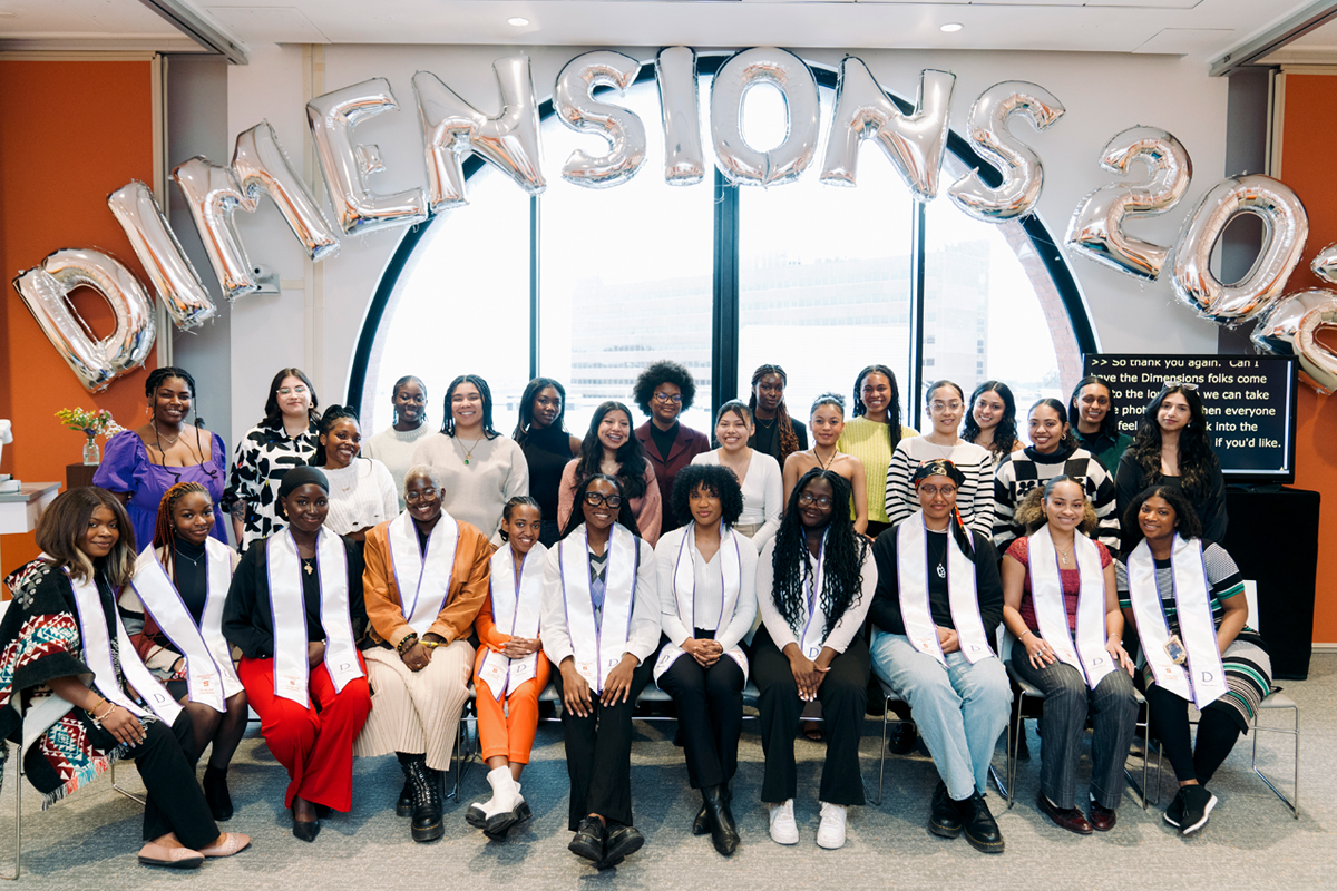 A group of students gather during a Women's History Month Reception.