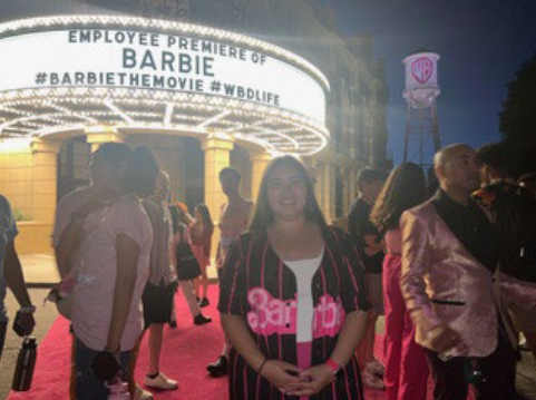 person standing in front of movie marquee