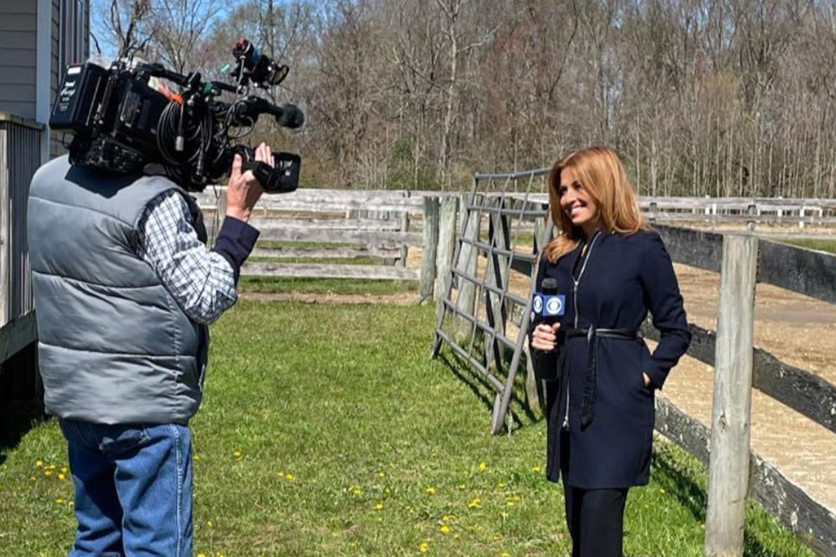 A videographer and a reporter on the scene of a local news story.