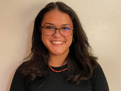 A woman smiles while posing for a headshot.