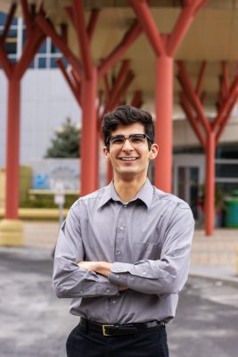 A man smiles while posing for a headshot.