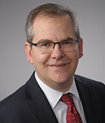 person with suit and tie looking forward