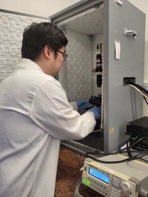 man doing experiment in a science lab cabinet