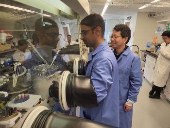 two men work with lab equipment in a science lab