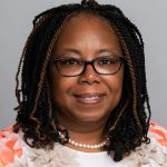 woman with glasses looking ahead