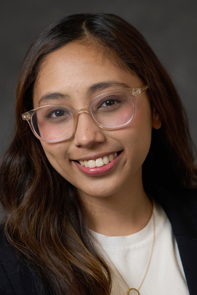A woman smiles while posing for a headshot.