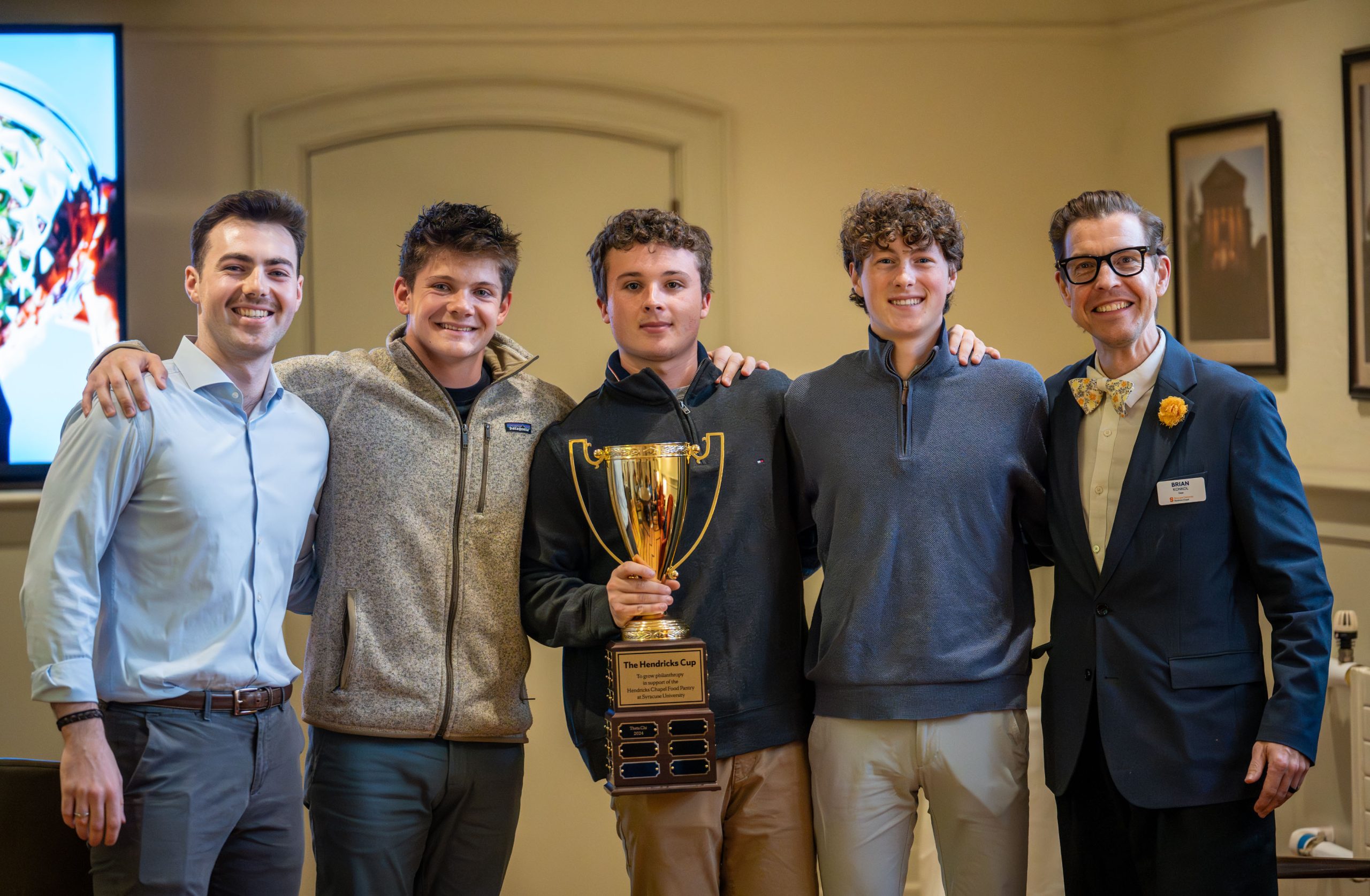 Five people standing together for a photo