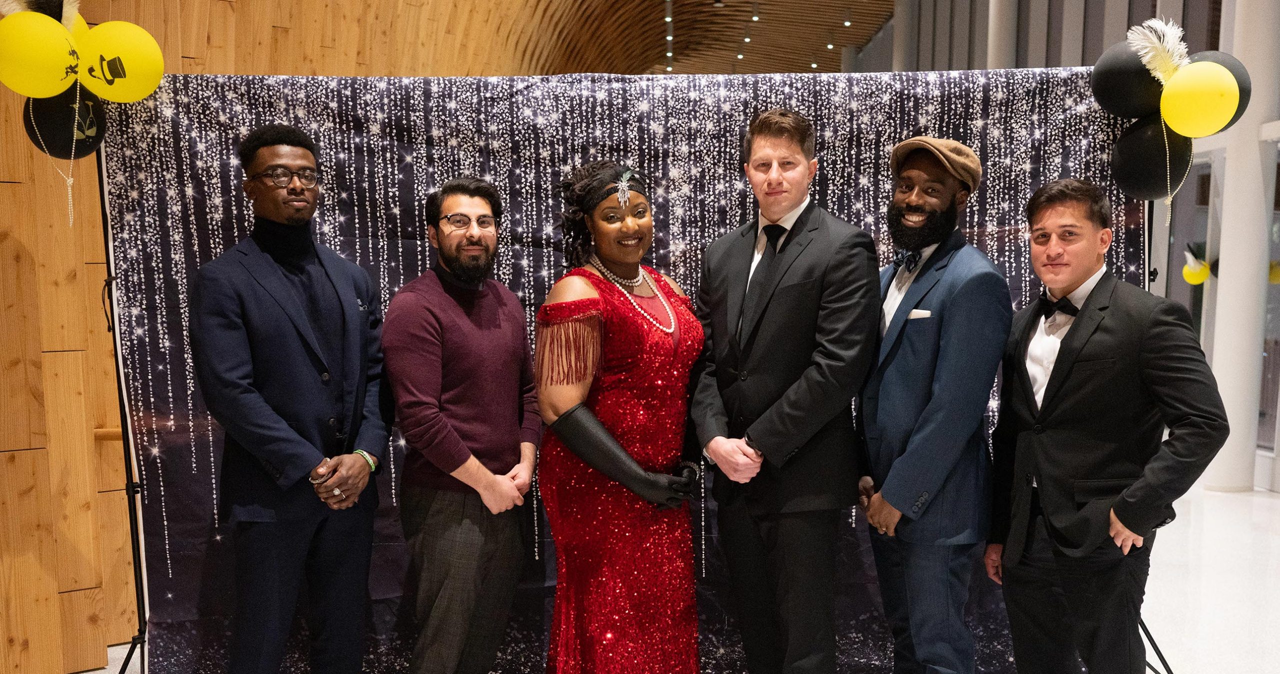 Six people standing together to take a photo together