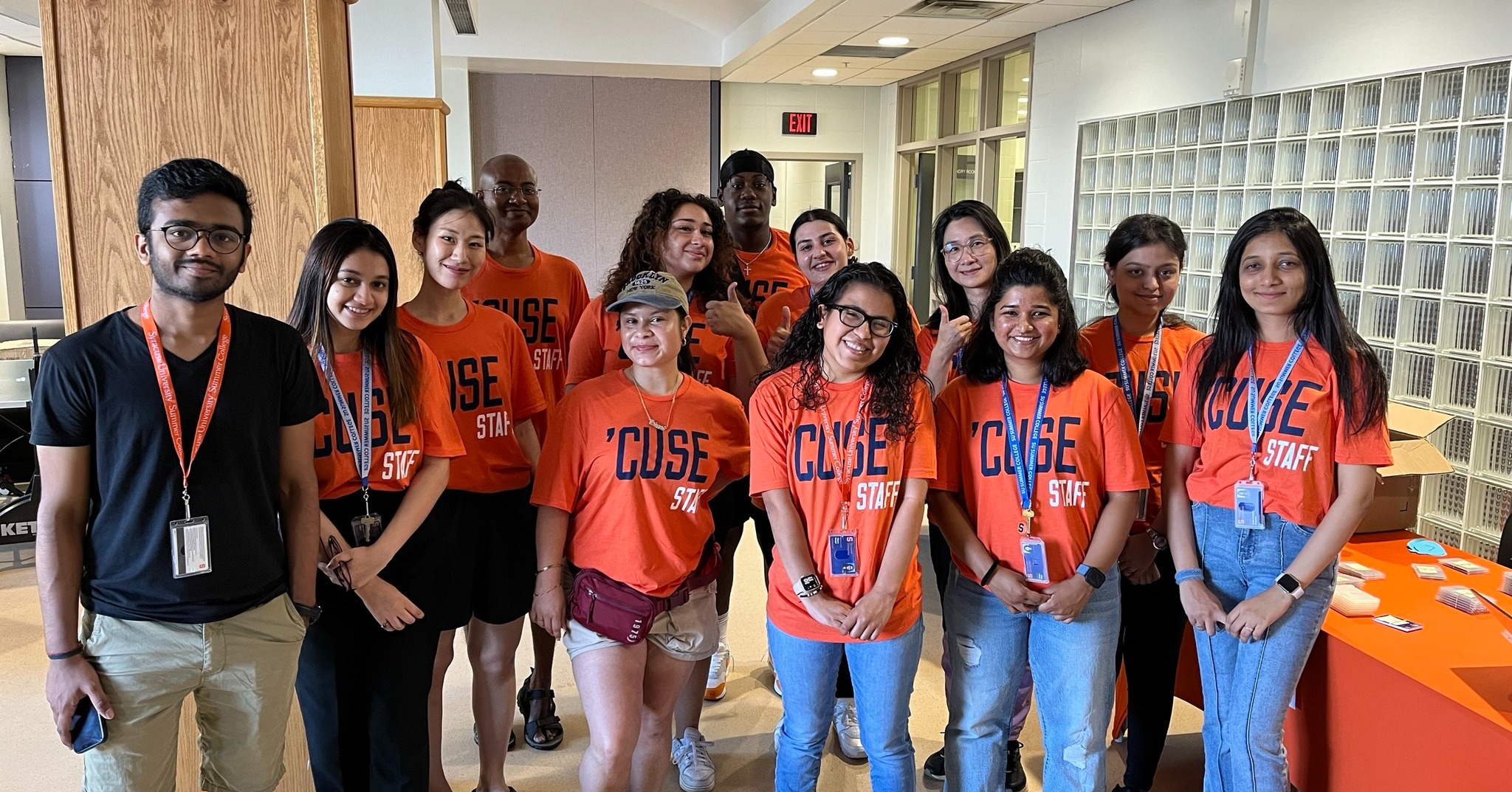 Group of students all standing together in orange tshirts. 