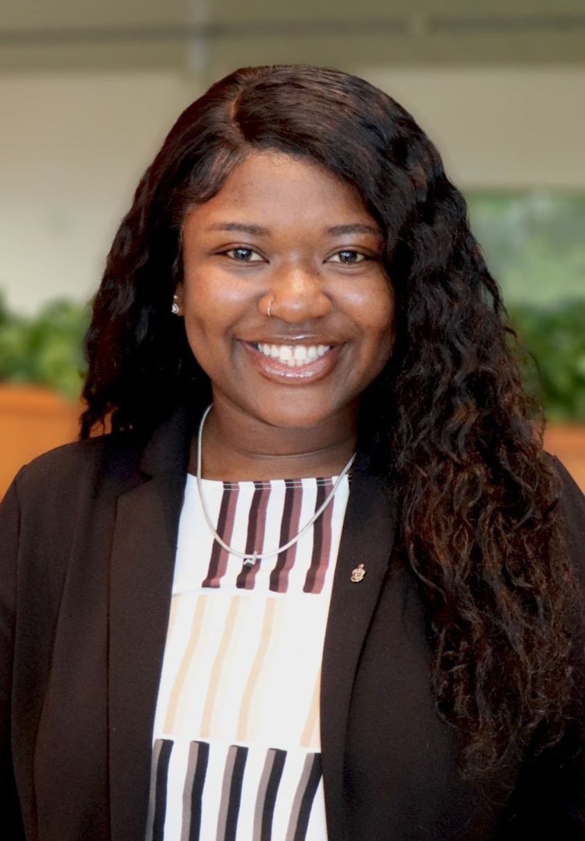 A woman smiles while posing for a headshot.