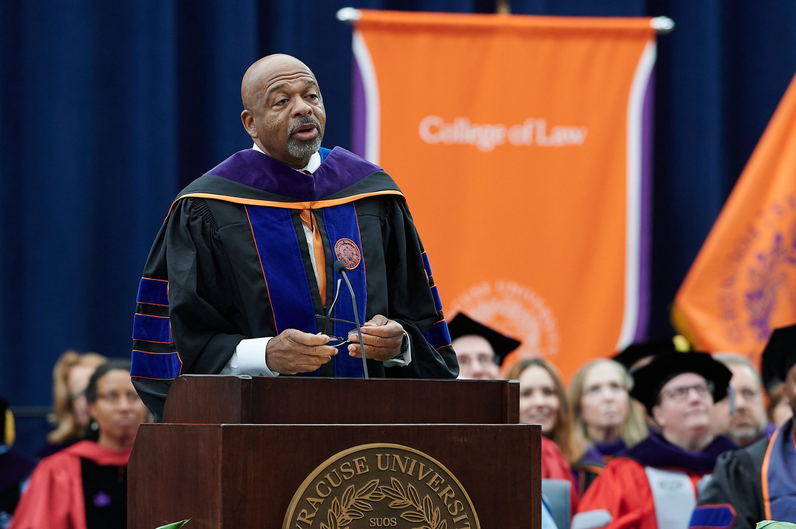 Man standing at podium speaking