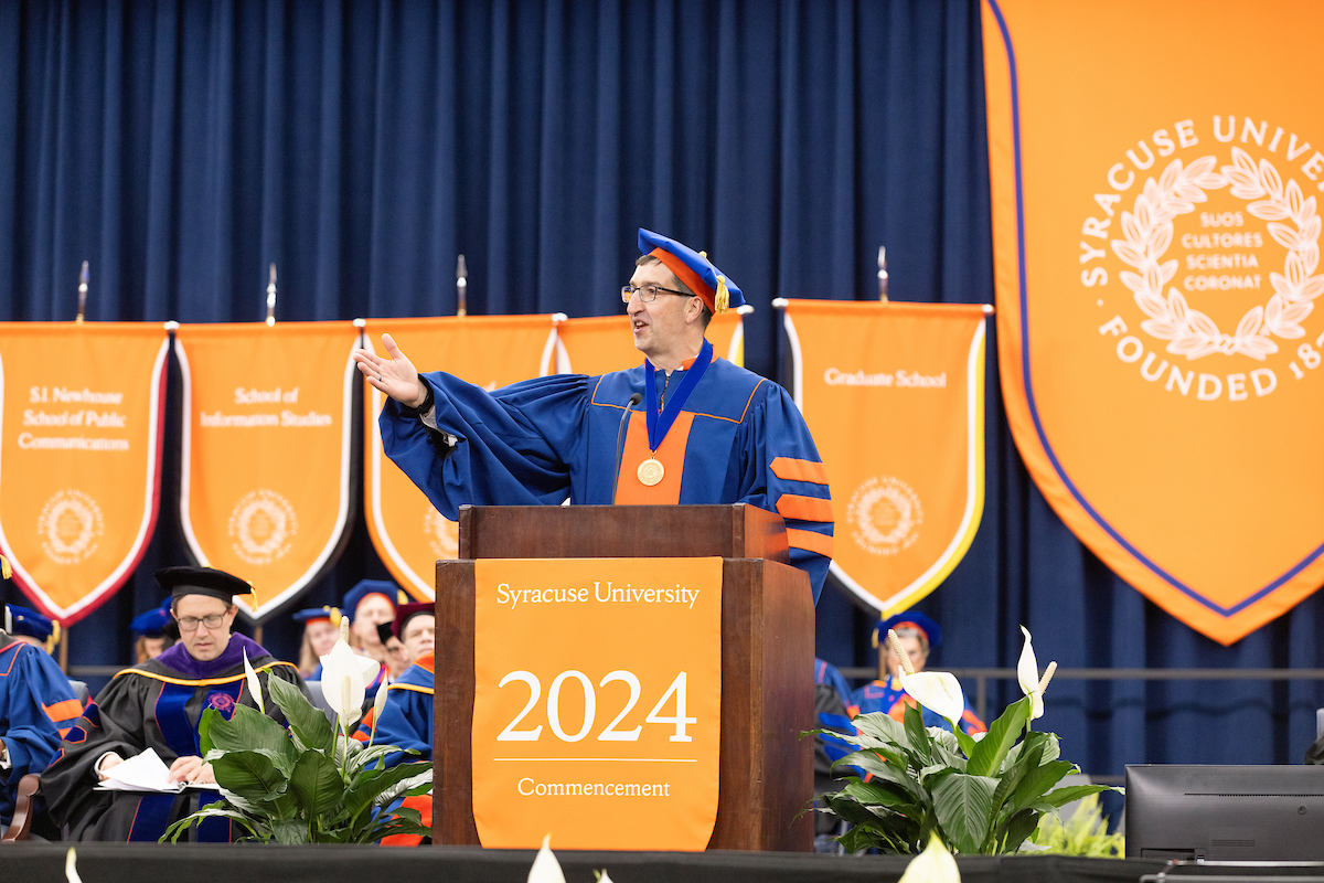 Person standing at the podium speaking at Commencement 