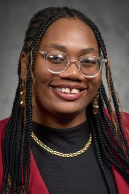A woman smiles while posing for a headshot.