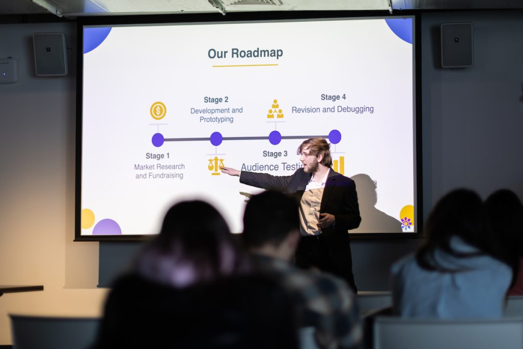 young person pointing out information on a projection screen