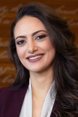 A woman smiles while posing for a headshot.