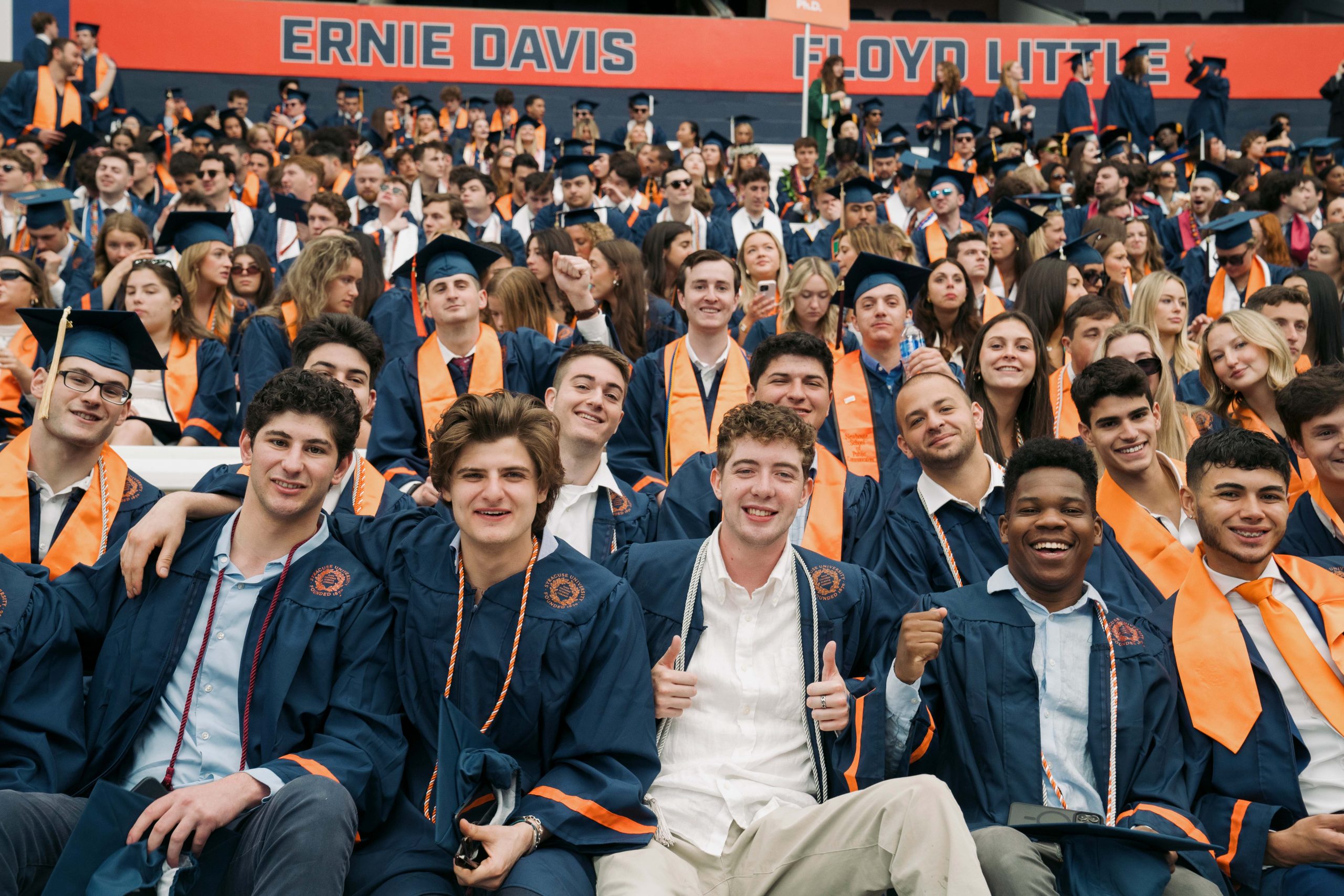 Graduates sitting in the stands waiting for Commencement to begin
