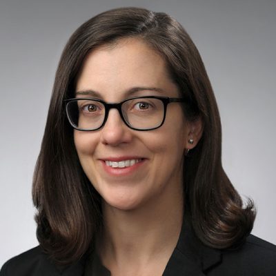 A woman smiles while posing for a headshot.