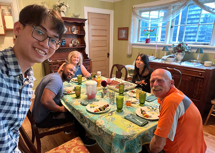 several people gathered at a dining room table